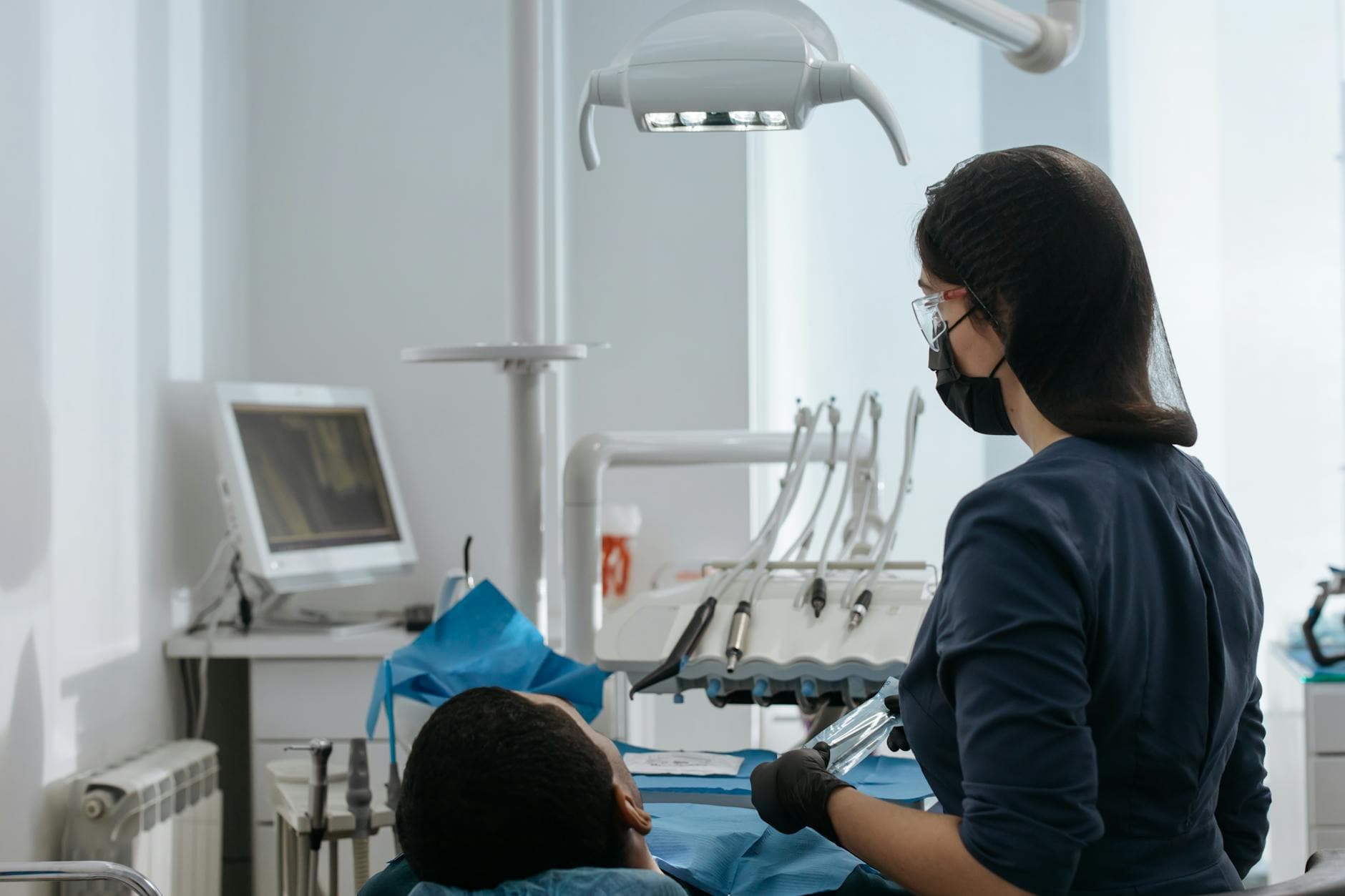Dentist conducting a thorough checkup on a patient in a modern dental clinic setting.