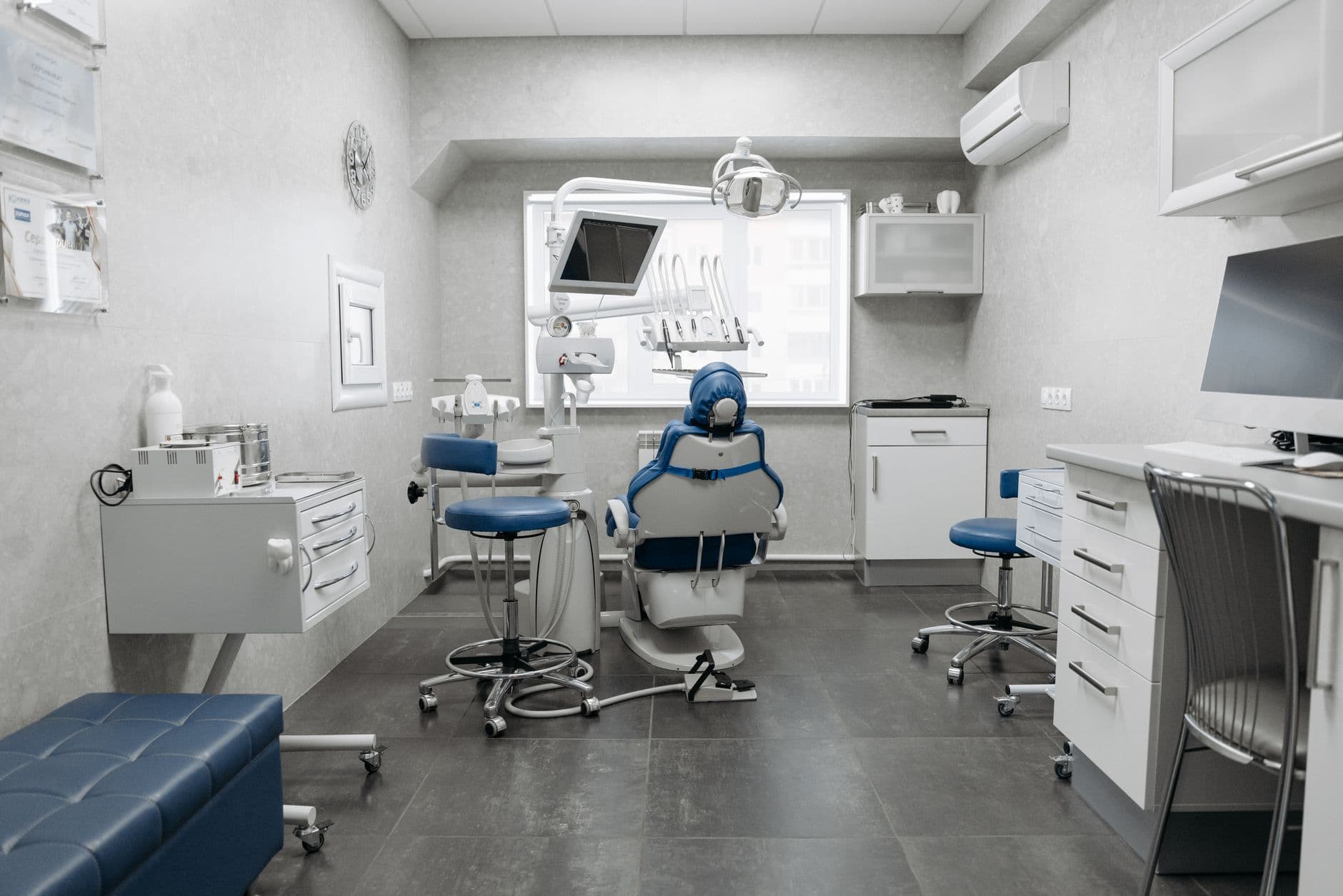 Spacious dental clinic with modern equipment and clean, white design.