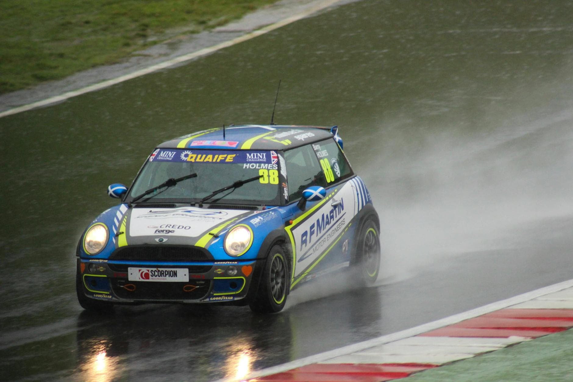 Action-packed car racing on a rainy track. Intense speed and splashes.