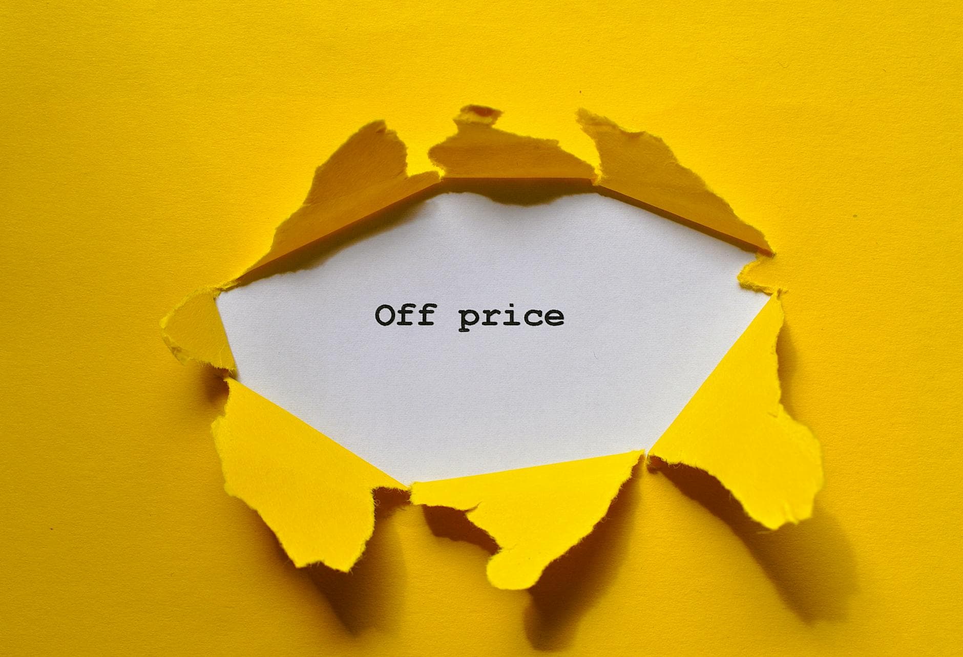 Yellow torn paper revealing 'Off price' for sale and discount promos.