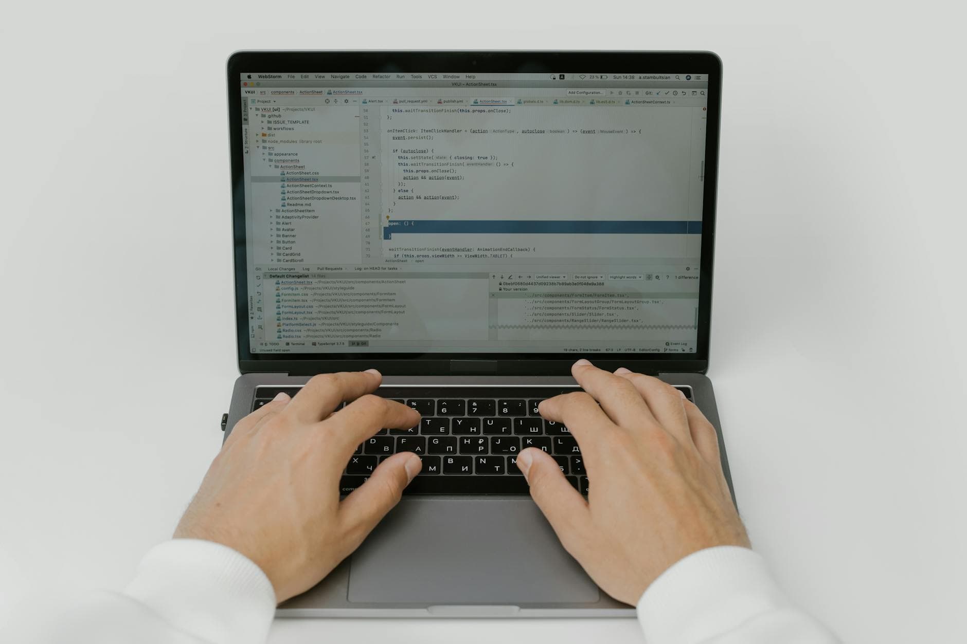Close-up of hands coding on a laptop, showcasing software development in action.