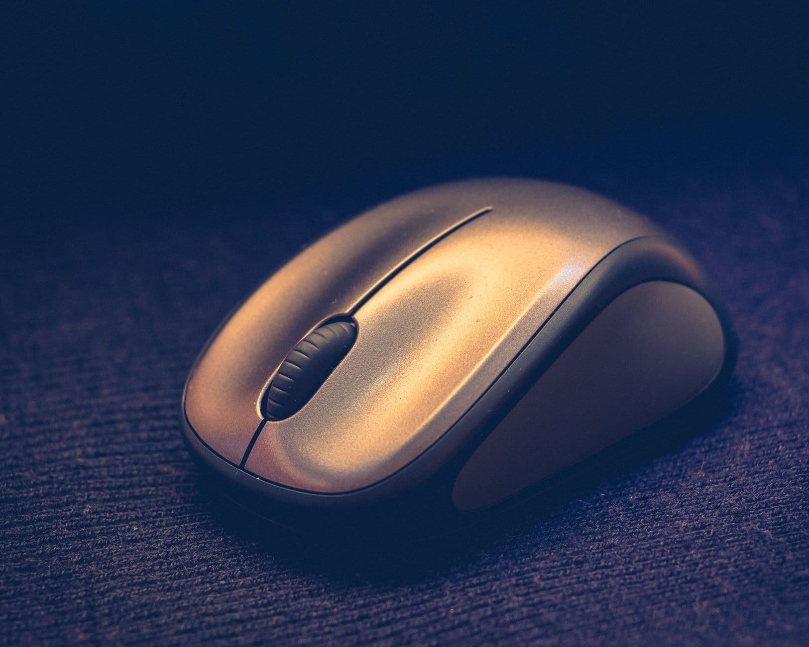 Elegant close-up of a sleek wireless computer mouse on a textured surface.